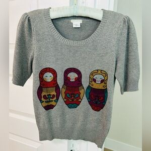 Cooperative Gray Sweater with colorful nesting dolls